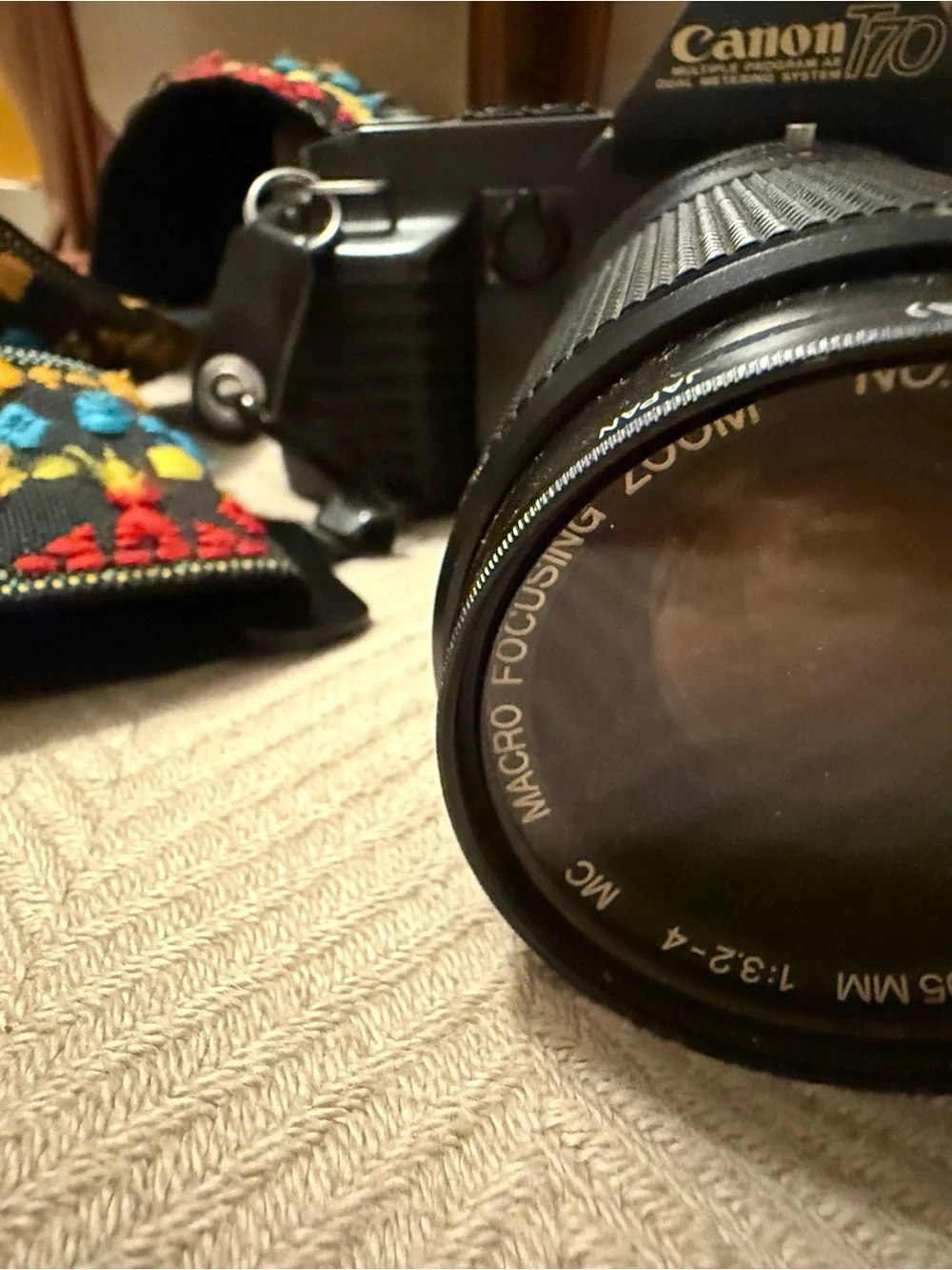 Canon T-70 35mm film camera with 35mm-105mm Zoom Lens with Multicolor Strap
